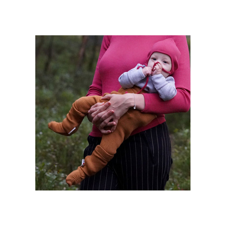 wool booties on a baby in mom's arms