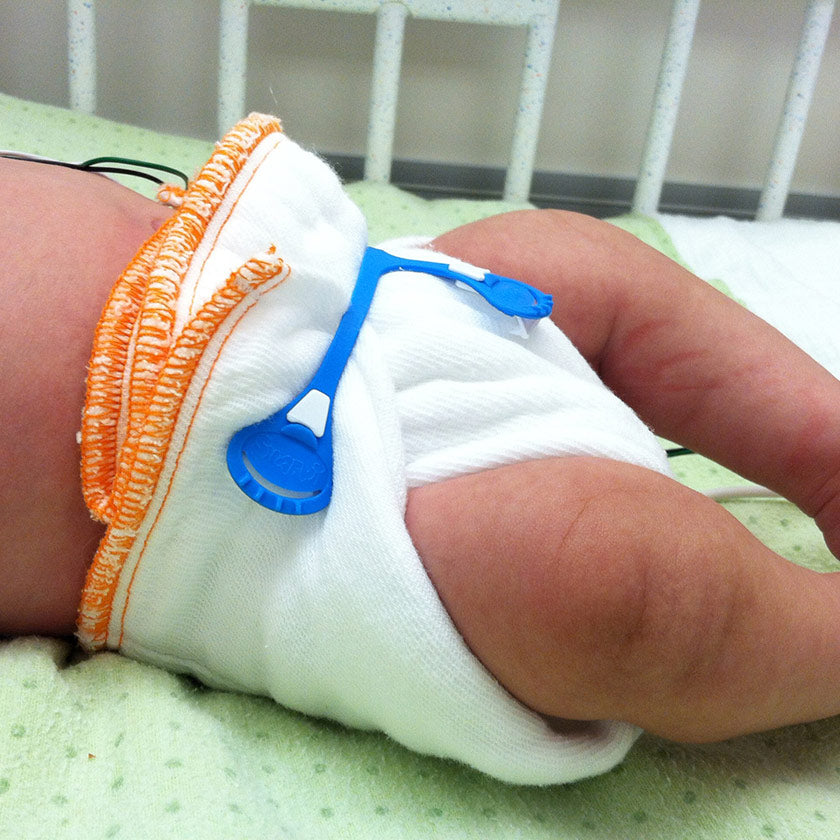Newborn prefold diaper on a newborn baby with a blue snappi