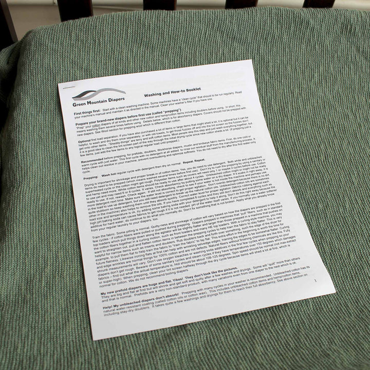 Green Mountain Diapers How-to Cloth diaper washing booklet shown on a green changing table