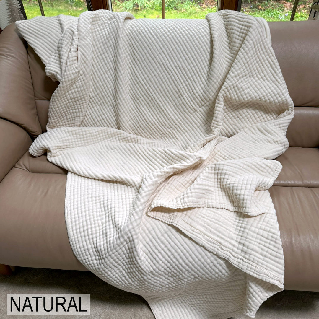 natural cotton organic muslin blanket on a couch