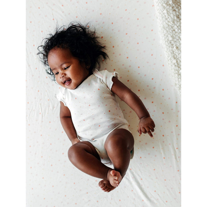 Baby on Under the Nile organic cotton crib sheet