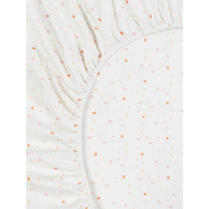 organic cotton fitted crib sheet with small orange dots on a white background