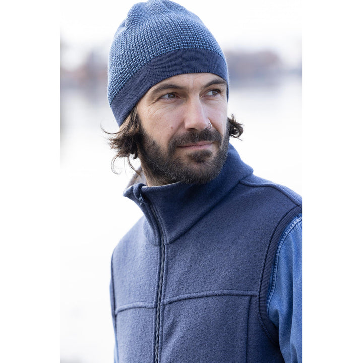 Man wearing a blue organic wool beanie and jacket  by Disana