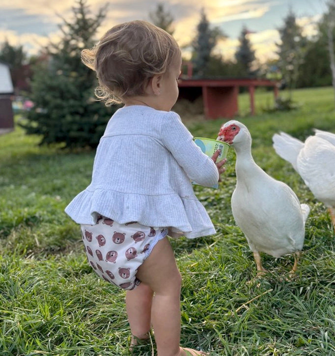 Mother-ease diaper on child feeding ducks
