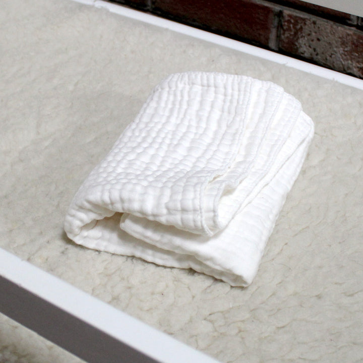 baby changing cloth folded on changing table
