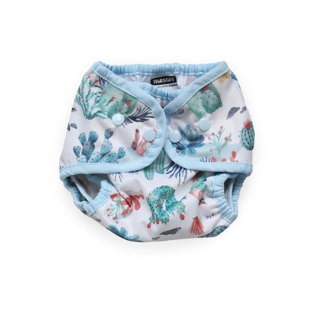 Thirsties Cover reusable cloth diaper with a light blue trim and a white background printed with a colorful Desert Dunes print size small