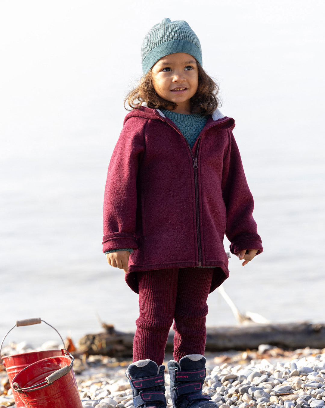 Child wearing wool disana beanie hat standing