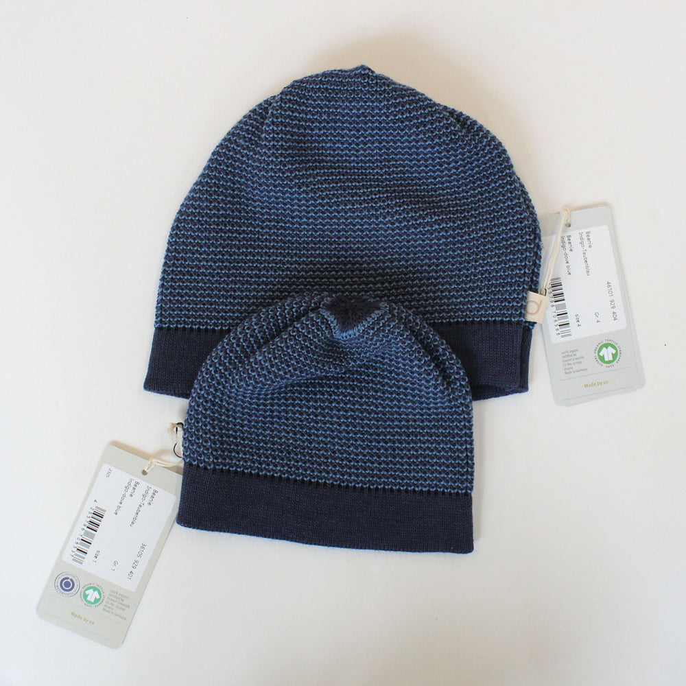 Two blue Disana organic wool knit baby hats size comparison