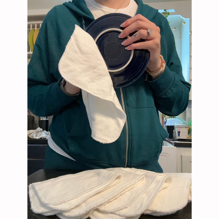 not paper towel kitchen cloth wiping a dish in kitchen by pregnant mother
