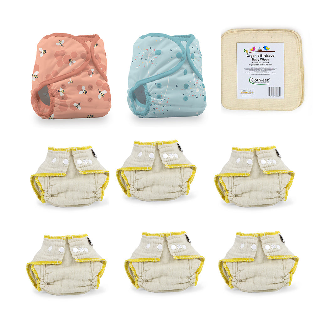 A set of reusable cloth diapers including two patterned diapers (one peach with bee print, one light blue with star print), cloth wipes and organic fitted diapers