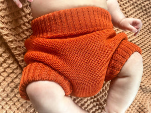 baby in organic wool orange diaper cover