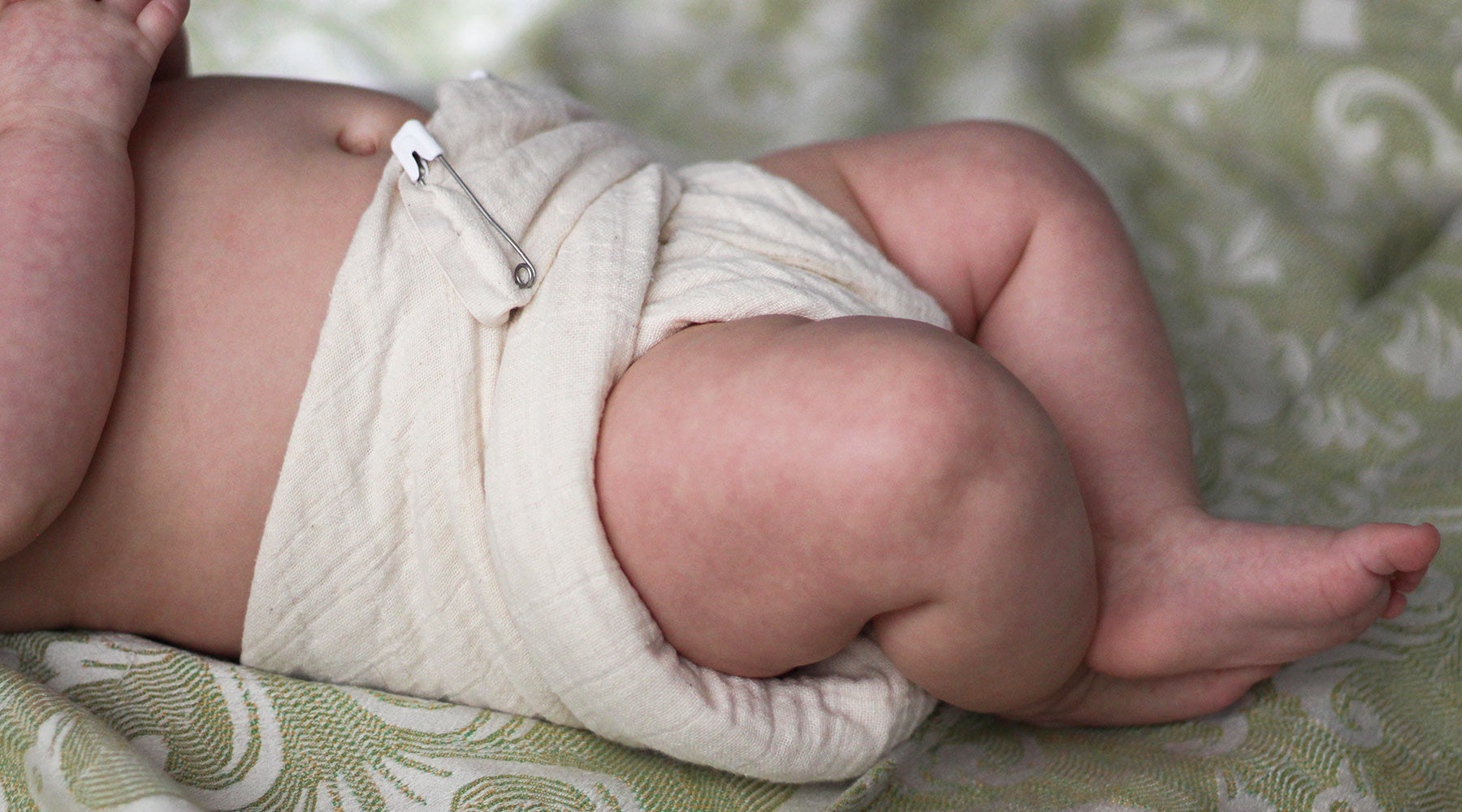 Cloth-eez Muslin Flat on a baby with a daiper pin
