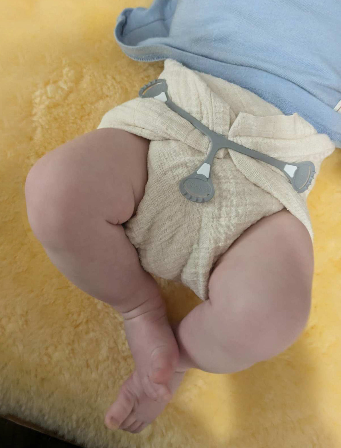 baby in Cloth-eez muslin flat diaper with a snappi