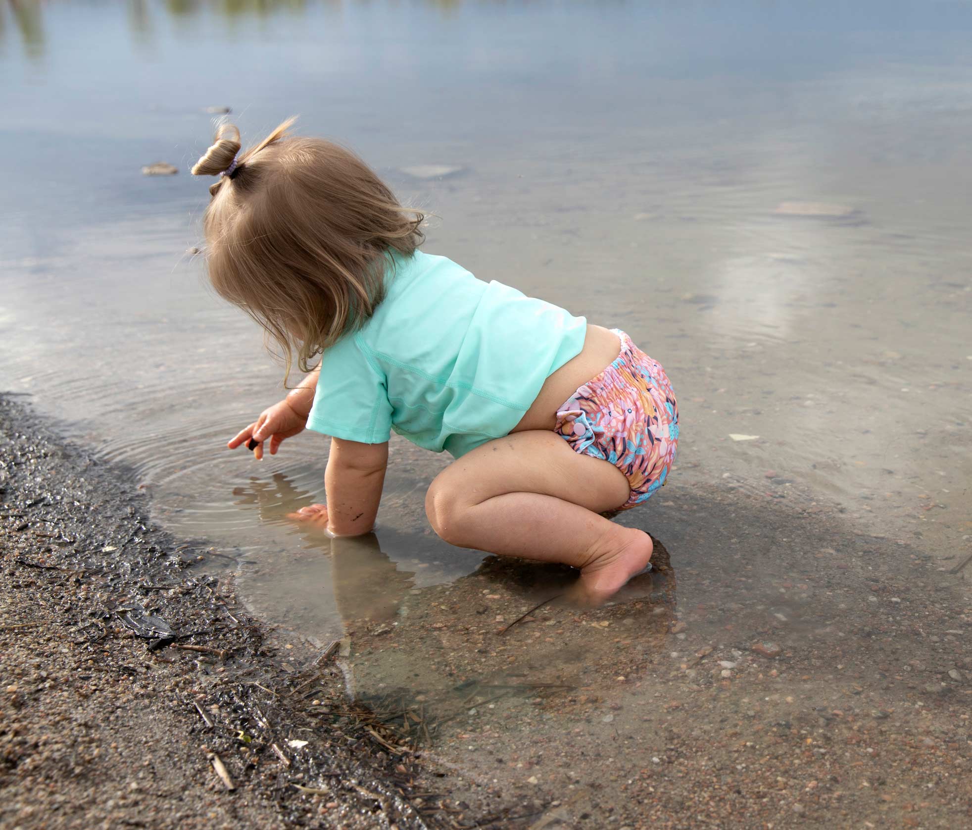 Thirsties swim diaper on baby at river