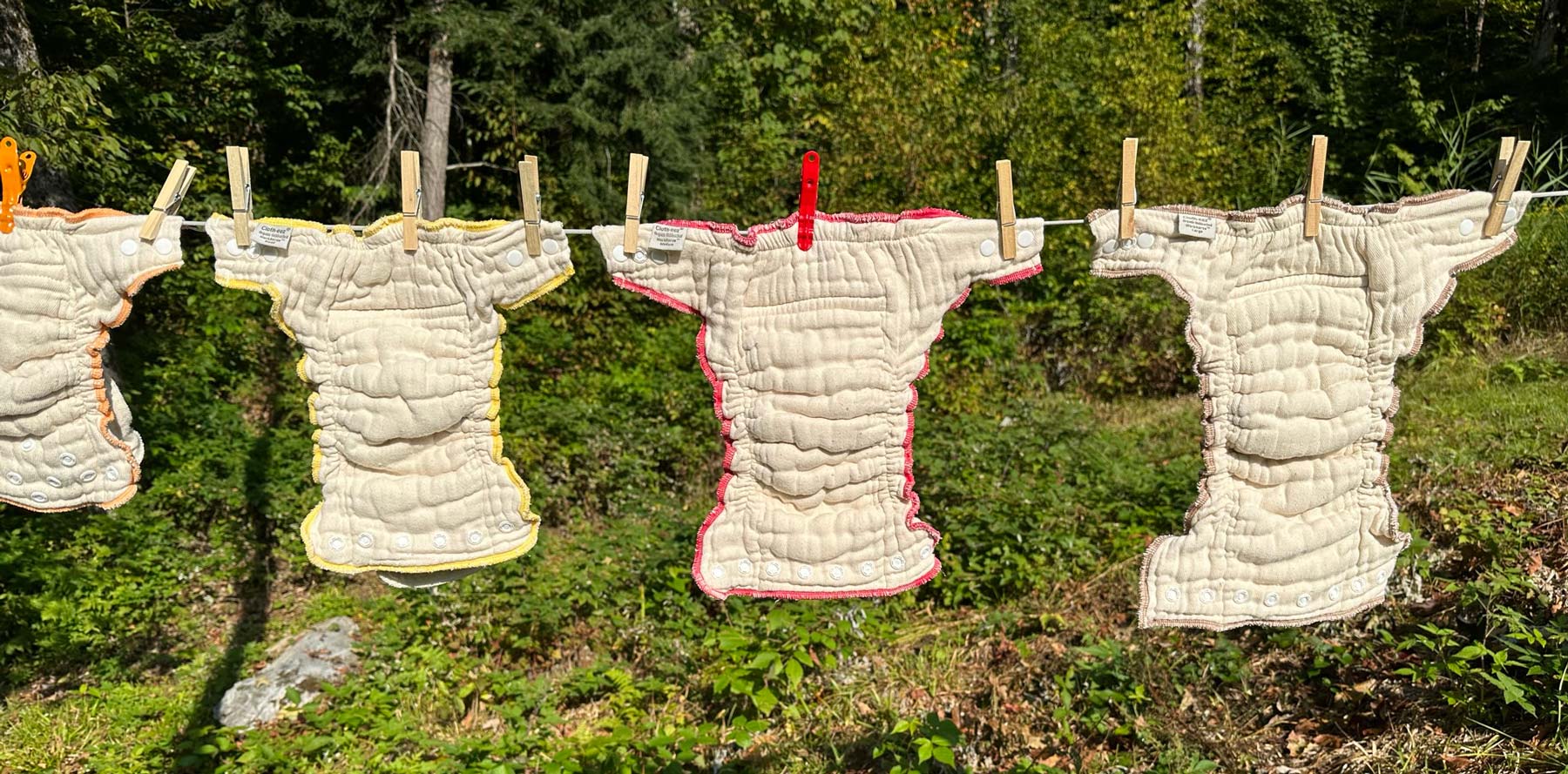 Organic cloth diapers workhorse hanging on a line outside