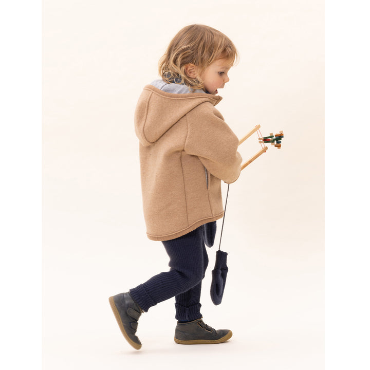 Child wearing a beige caramel Disana boiled wool organic hooded coat 