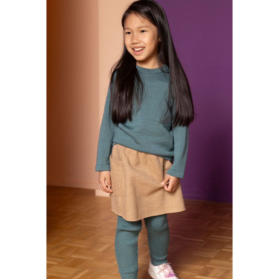 Young girl wearing organic merino wool leggings