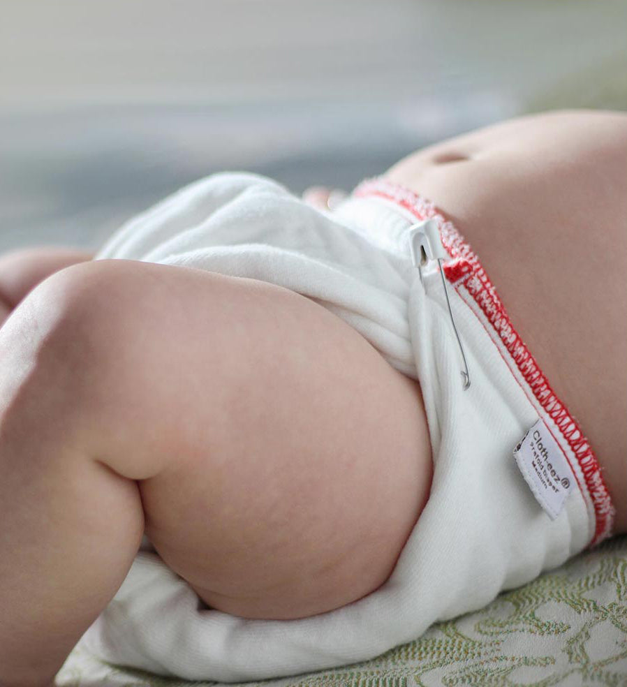 prefold cloth diaper on a baby