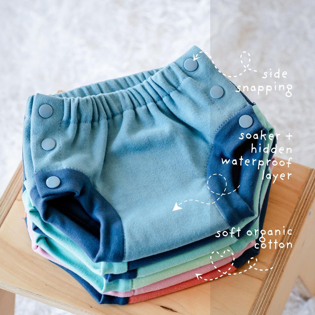 Stack of Thirsites potty training pants with features described. Hidden waterproof layer and absorbent soaker