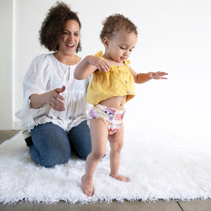 baby walking in cloth diaper