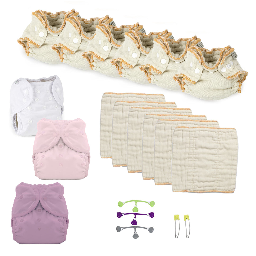 Collection of cloth diapers, covers, and accessories on a white background Newborn cloth diaper kit pink and purple for a girl