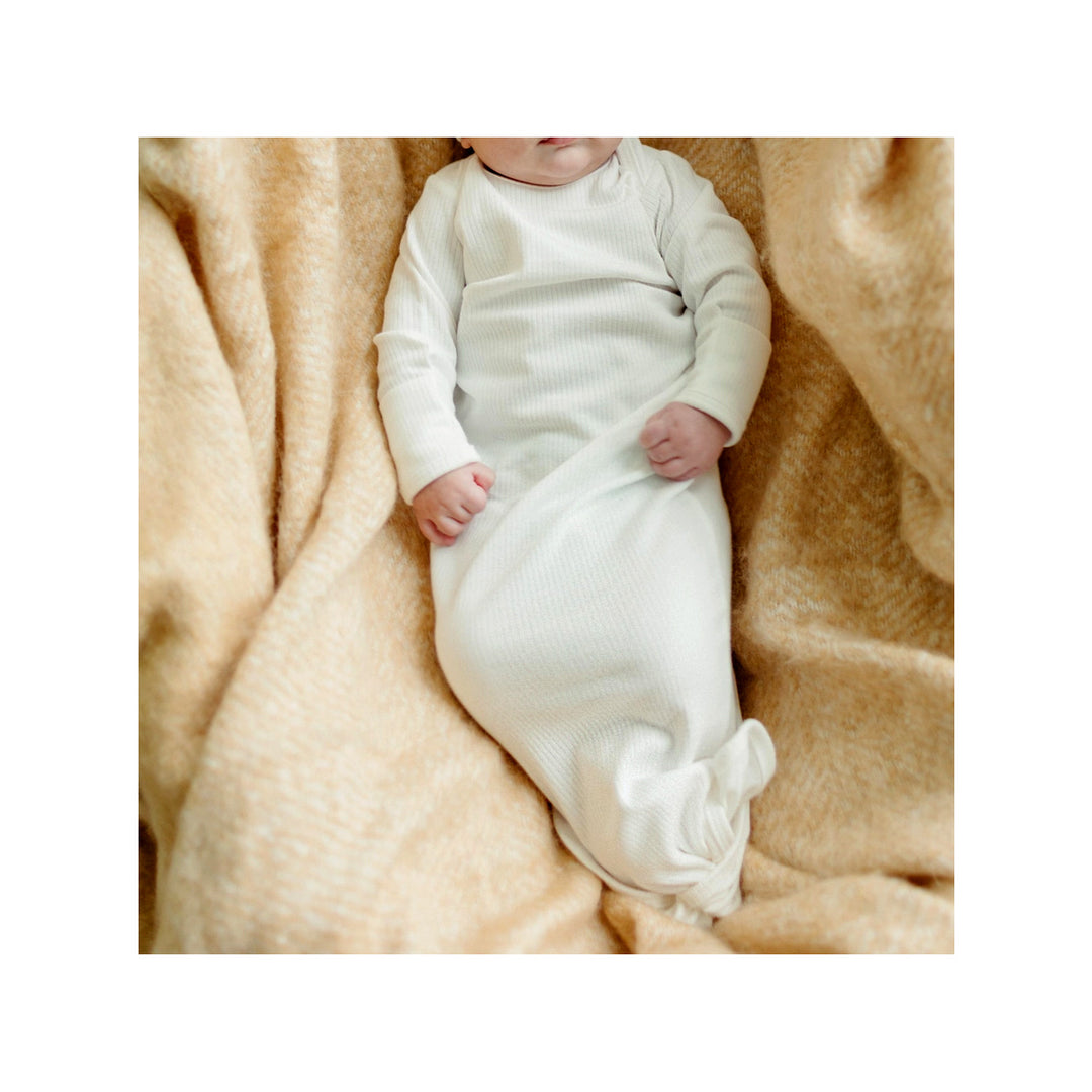 Baby wearing organic cotton knotted gown drop needle white