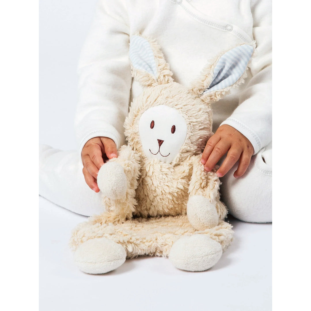 Baby holding Under the Nile snuggle bunny with blue stripes ears organic cotton
