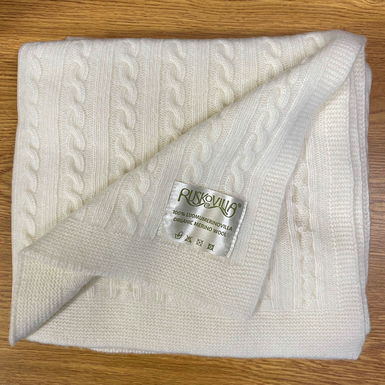 Ruskovilla organic merino wool baby blanket on a table